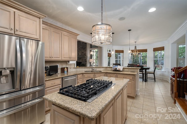 kitchen featuring appliances with stainless steel finishes, decorative backsplash, light brown cabinetry, crown molding, and kitchen peninsula