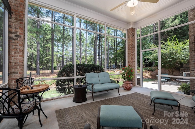 sunroom featuring ceiling fan and a healthy amount of sunlight