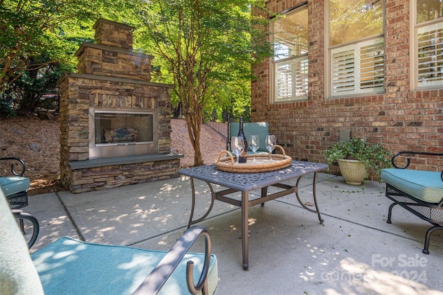 view of patio / terrace with an outdoor stone fireplace