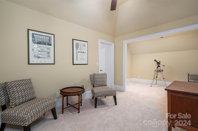 sitting room featuring carpet and lofted ceiling