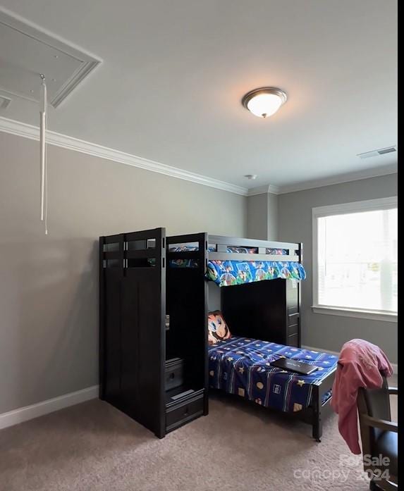 bedroom featuring carpet flooring, visible vents, crown molding, baseboards, and attic access
