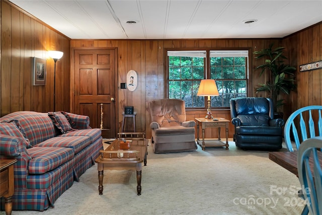 living room featuring carpet flooring and wooden walls