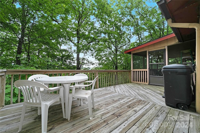 wooden deck featuring a sunroom