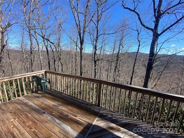 wooden deck with a forest view