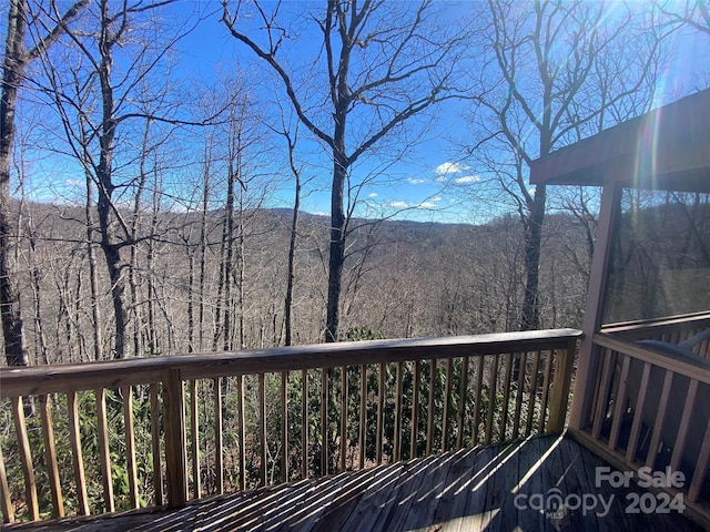 wooden deck featuring a view of trees