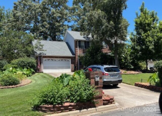 view of front of property with a garage and a front yard