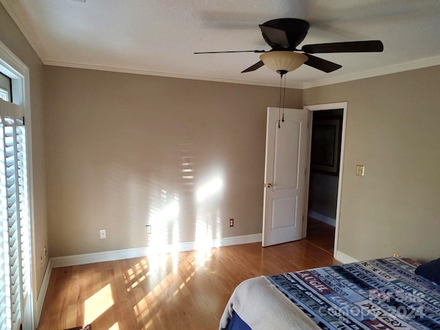 bedroom with ceiling fan, light hardwood / wood-style flooring, and crown molding