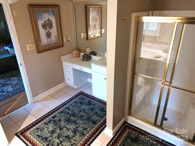 bathroom featuring vanity, tile patterned floors, and a shower with door