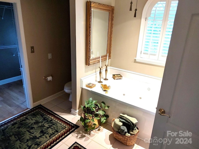 bathroom with toilet and tile patterned floors