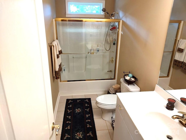 full bathroom featuring toilet, tile patterned flooring, enclosed tub / shower combo, and vanity