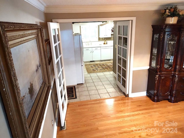 interior space featuring crown molding and light hardwood / wood-style floors