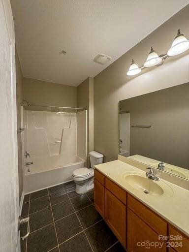 full bathroom featuring toilet, vanity,  shower combination, and tile patterned flooring