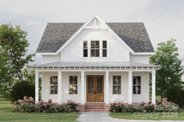 view of front of home with covered porch and a front lawn