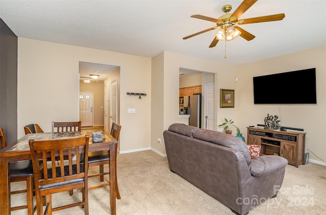 living room featuring light carpet and ceiling fan