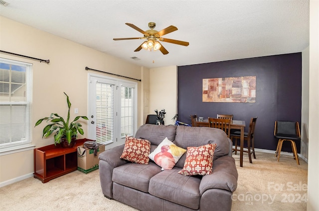 carpeted living room featuring ceiling fan