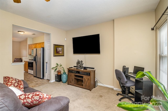 carpeted living room featuring a textured ceiling