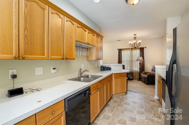 kitchen featuring sink, pendant lighting, a notable chandelier, dishwasher, and stainless steel refrigerator