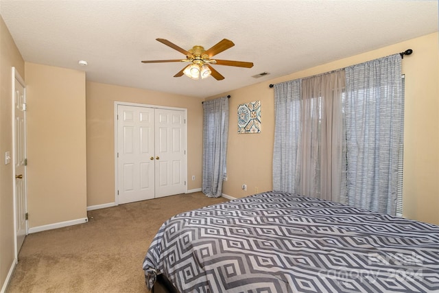 bedroom featuring ceiling fan, light colored carpet, and a closet