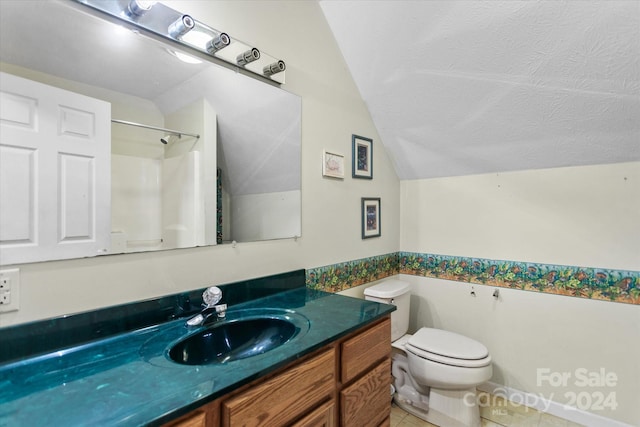 bathroom with toilet, a textured ceiling, walk in shower, vanity, and lofted ceiling