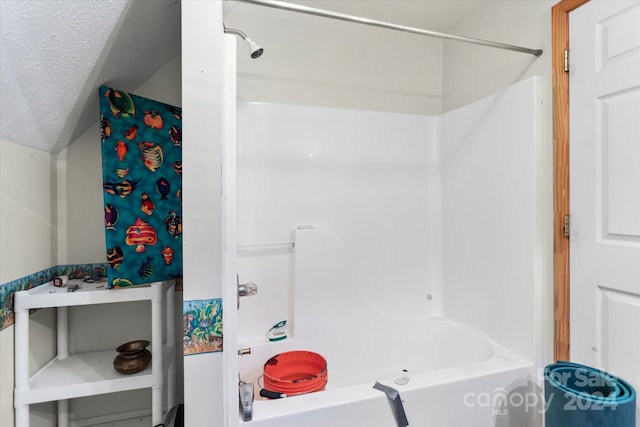 bathroom featuring a textured ceiling and shower / washtub combination