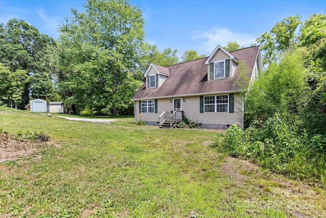 rear view of property with a storage unit and a lawn