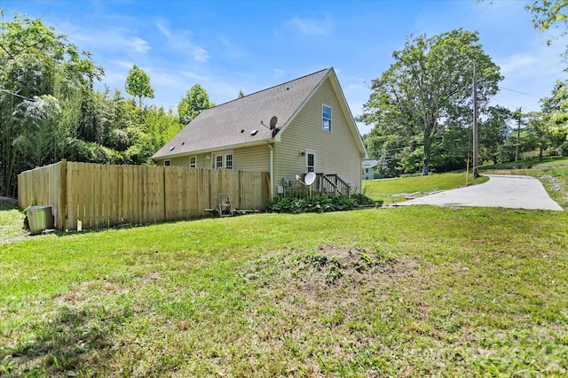 view of property exterior with a lawn