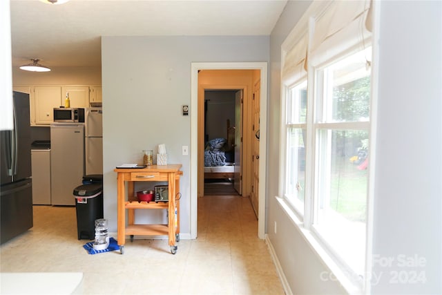 hall featuring light tile floors