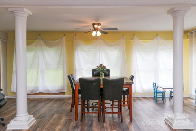 dining space with dark wood-type flooring, ceiling fan, and decorative columns