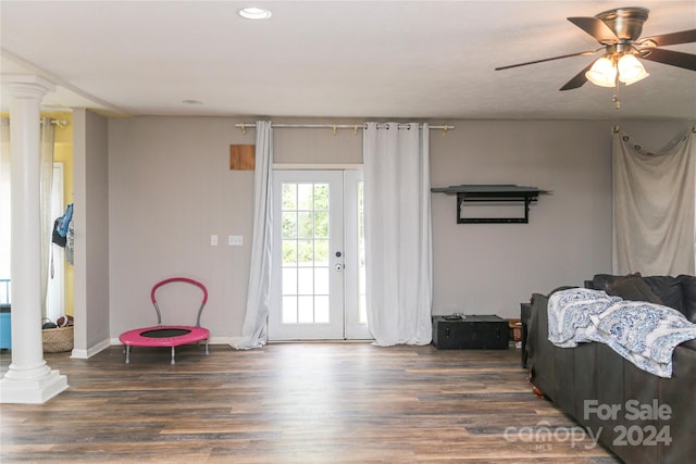 interior space featuring dark hardwood / wood-style floors, ceiling fan, and decorative columns