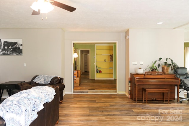 living room featuring ceiling fan and wood-type flooring