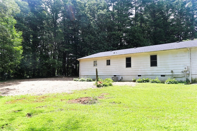 rear view of property with a yard and central air condition unit