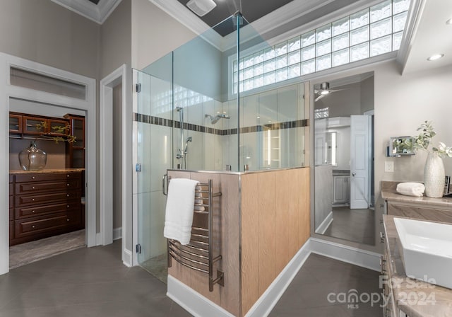 bathroom featuring vanity, a shower with door, tile patterned floors, ceiling fan, and ornamental molding