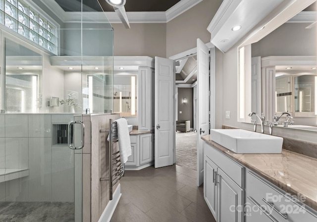 bathroom with vanity, a towering ceiling, ornamental molding, and walk in shower