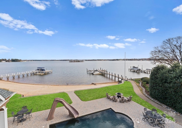 view of dock with a water view and a patio