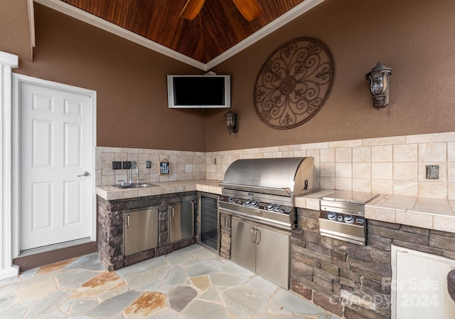 view of patio with area for grilling, sink, and an outdoor kitchen