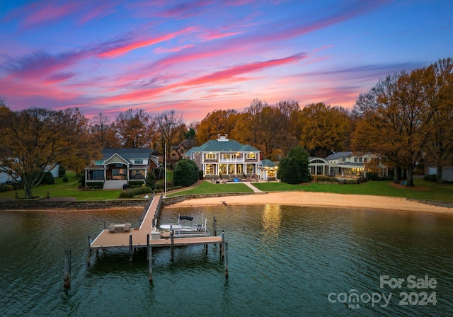 dock area featuring a yard and a water view