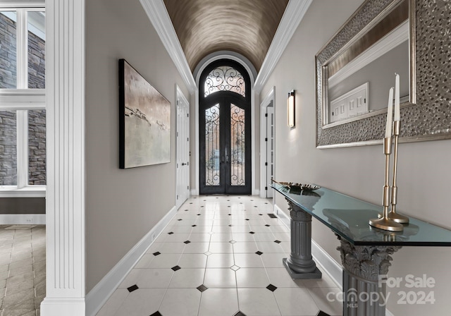 foyer with ornamental molding and french doors