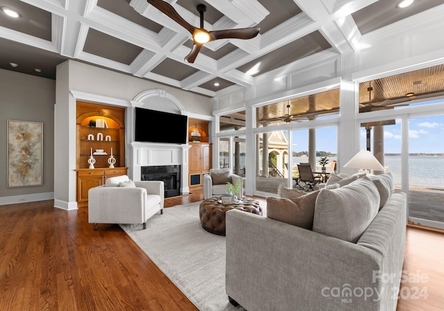 living room featuring hardwood / wood-style flooring, ceiling fan, a wealth of natural light, and coffered ceiling