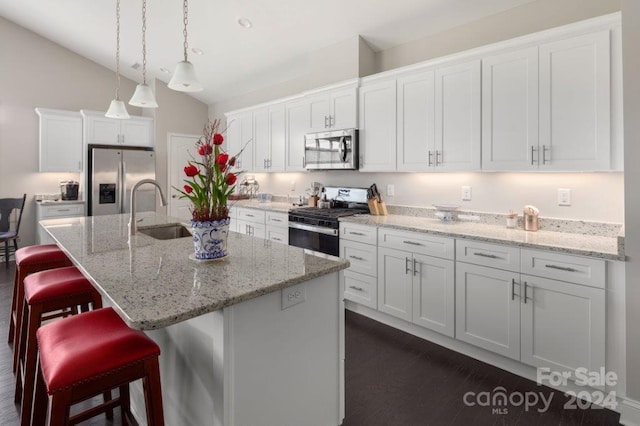 kitchen featuring white cabinetry, sink, an island with sink, and appliances with stainless steel finishes