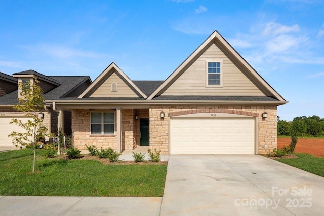 view of front of house with a garage, concrete driveway, a front yard, and roof with shingles