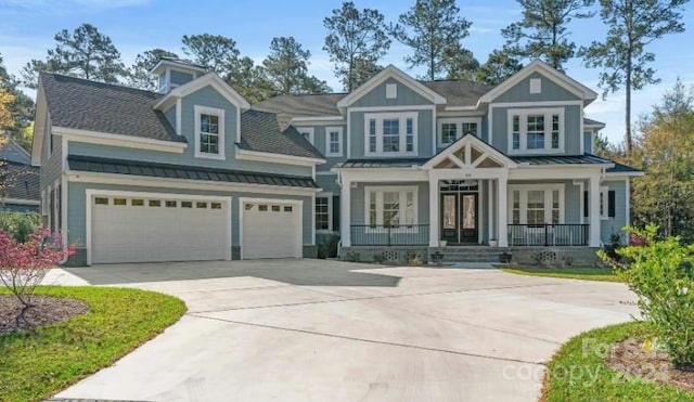 craftsman-style home with a garage, french doors, and covered porch