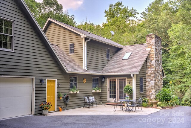 back of property with a garage