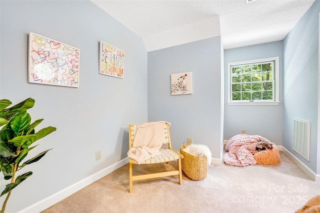 living area with carpet floors and vaulted ceiling