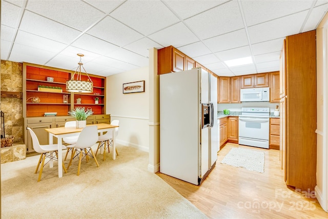 kitchen featuring white appliances, a drop ceiling, decorative light fixtures, built in shelves, and light hardwood / wood-style flooring