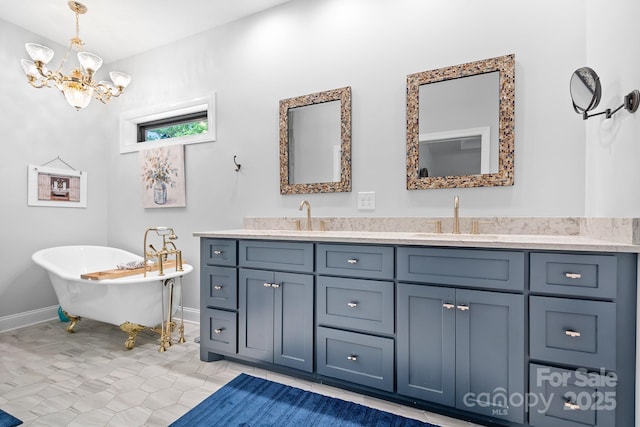 bathroom featuring tile patterned floors, a bathtub, vanity, and a chandelier