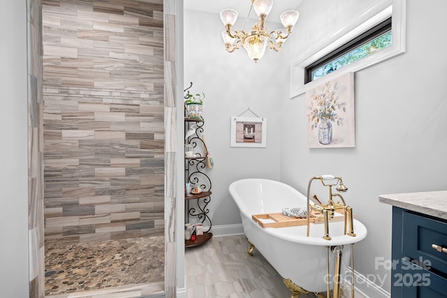 bathroom featuring tile patterned flooring, shower with separate bathtub, vanity, and an inviting chandelier