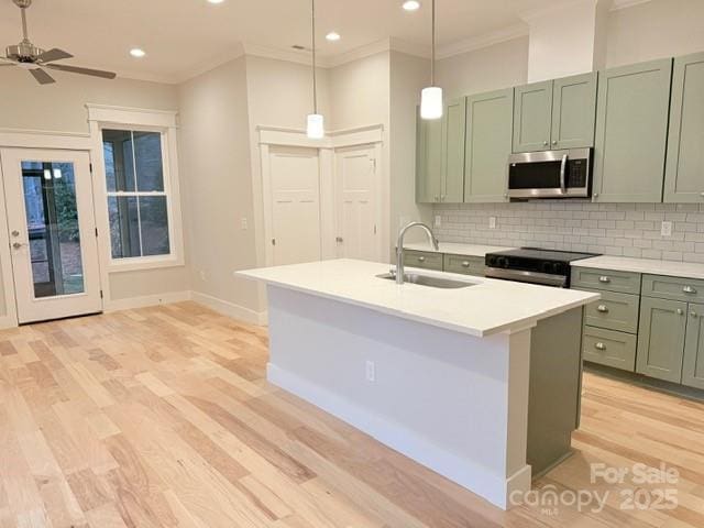 kitchen with sink, electric range oven, backsplash, and hanging light fixtures