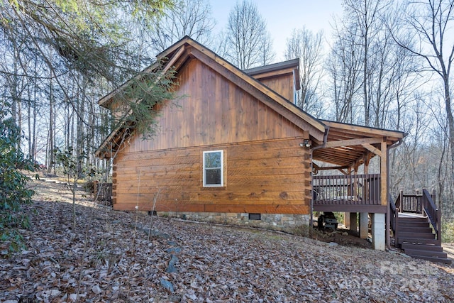 view of property exterior featuring a wooden deck