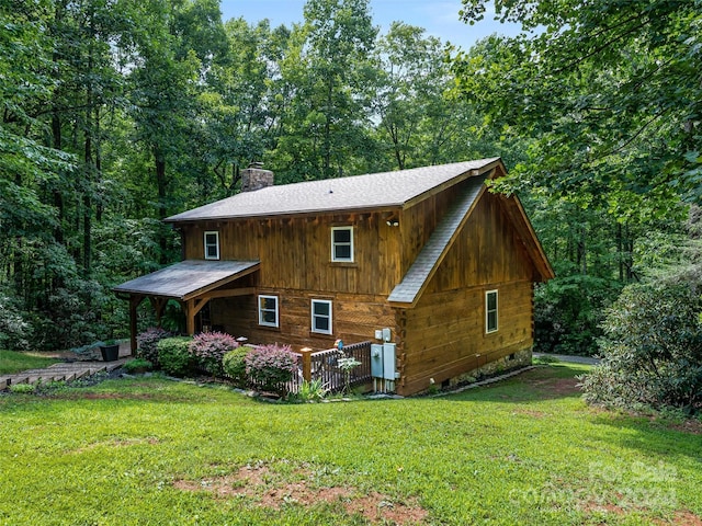 rear view of property featuring a lawn