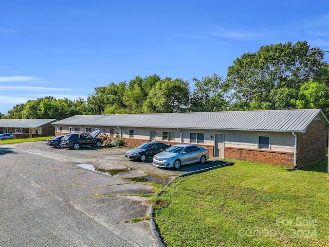 view of parking featuring a lawn